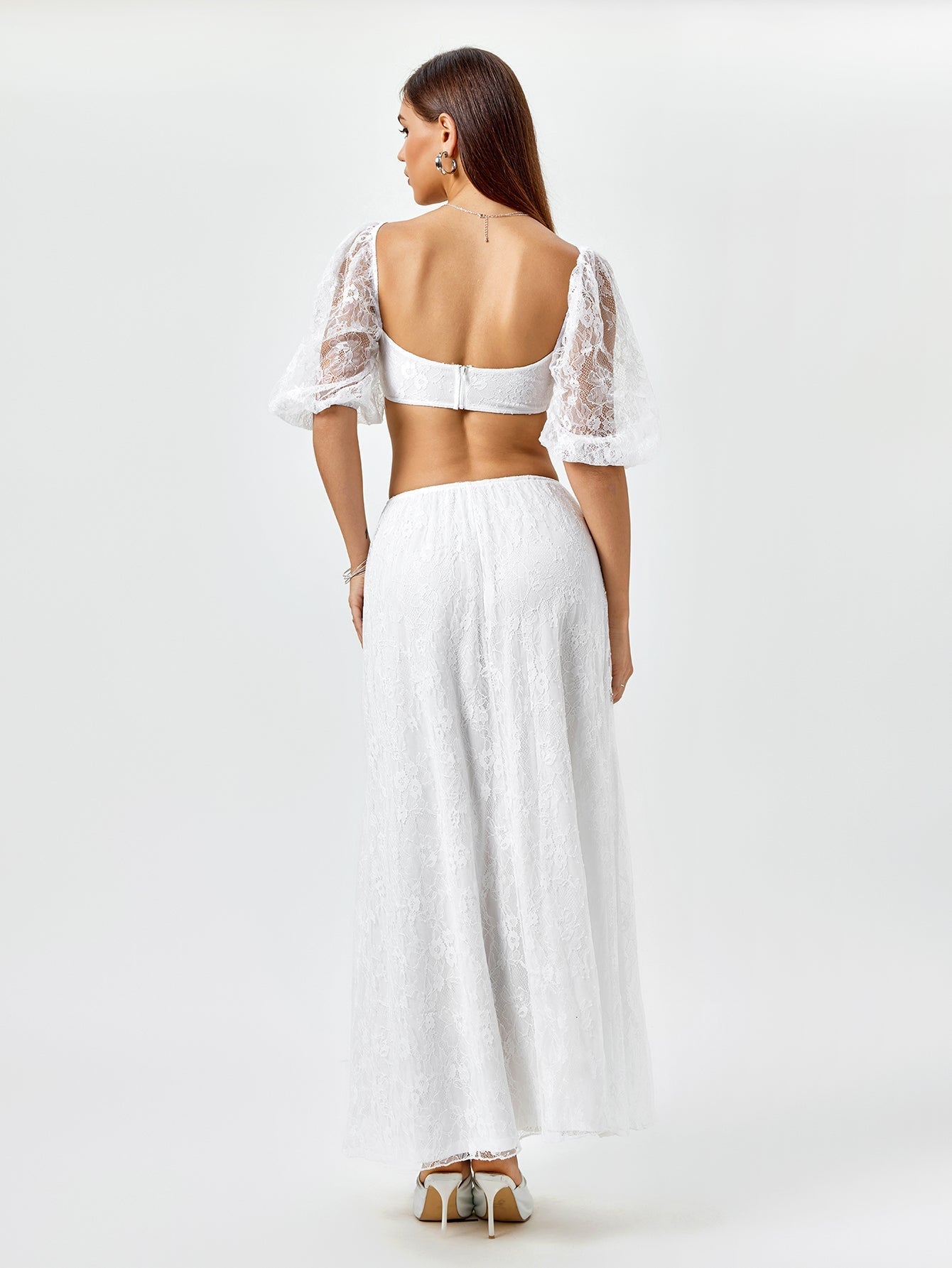 Back view of a woman in a white lace matching set