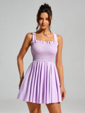 Close-up of a woman in a lavender smocked mini dress, highlighting the textured bodice