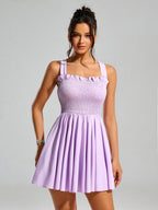 Close-up of a woman in a lavender smocked mini dress, highlighting the textured bodice