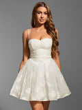 Woman wearing white embroidered floral sweetheart neckline spaghetti strap fit and flare dress smiling