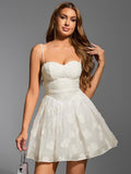 Woman wearing white embroidered floral sweetheart neckline spaghetti strap fit and flare dress holding a handbag