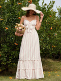 Woman wearing a floral print maxi dress, a straw hat, and holding a basket of flowers in an orchard.