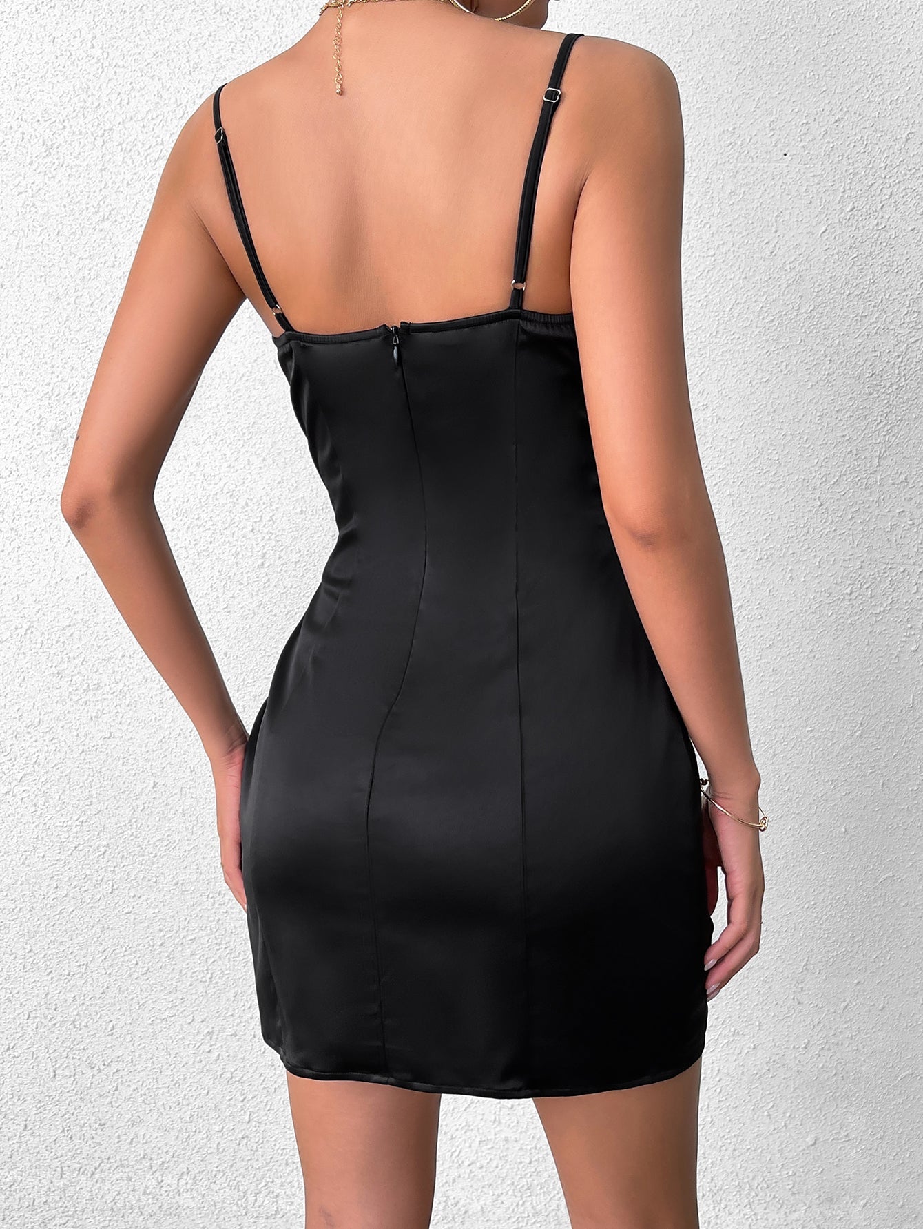 back view of black satin mini dress