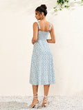 Back view of a woman in a white floral print midi dress with a smocked back and spaghetti straps.