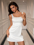 Woman wearing a white satin sleeveless square neck dress with button accents and a zipper closure.