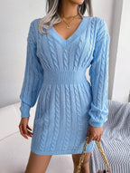 Model posing in a blue cable knit sweater dress