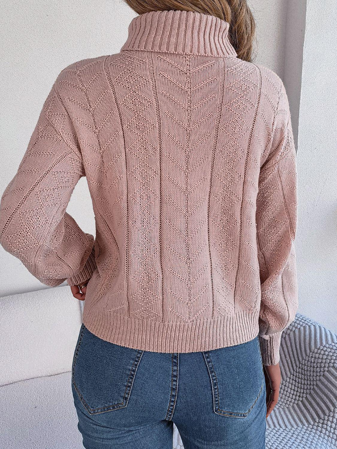 Back view of a woman in a pink cable knit turtleneck sweater