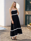 Model posing in a black textured midi dress with sweetheart neckline.