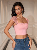 Front view of a woman with dark hair wearing a pink square neck crop top
