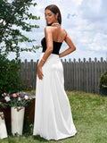 Back view of a woman in a black and white strapless maxi dress