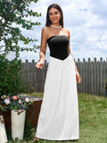 Woman wearing a black and white strapless maxi dress outdoors