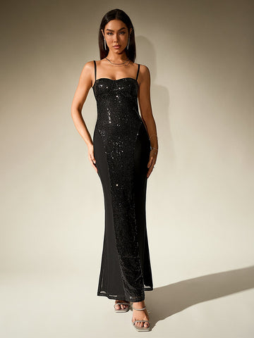 Woman in a black sequined and plain fabric column gown with spaghetti straps.