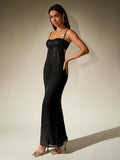 Front view of a woman wearing a black sequined and plain fabric column gown.
