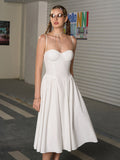 Close-up of the sweetheart neckline on a white midi dress