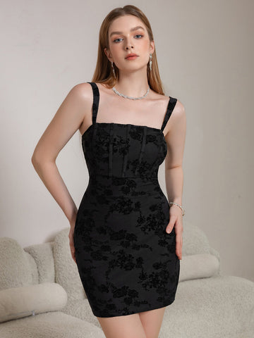Woman wearing a black floral jacquard sheath dress with spaghetti straps and a square neckline.
