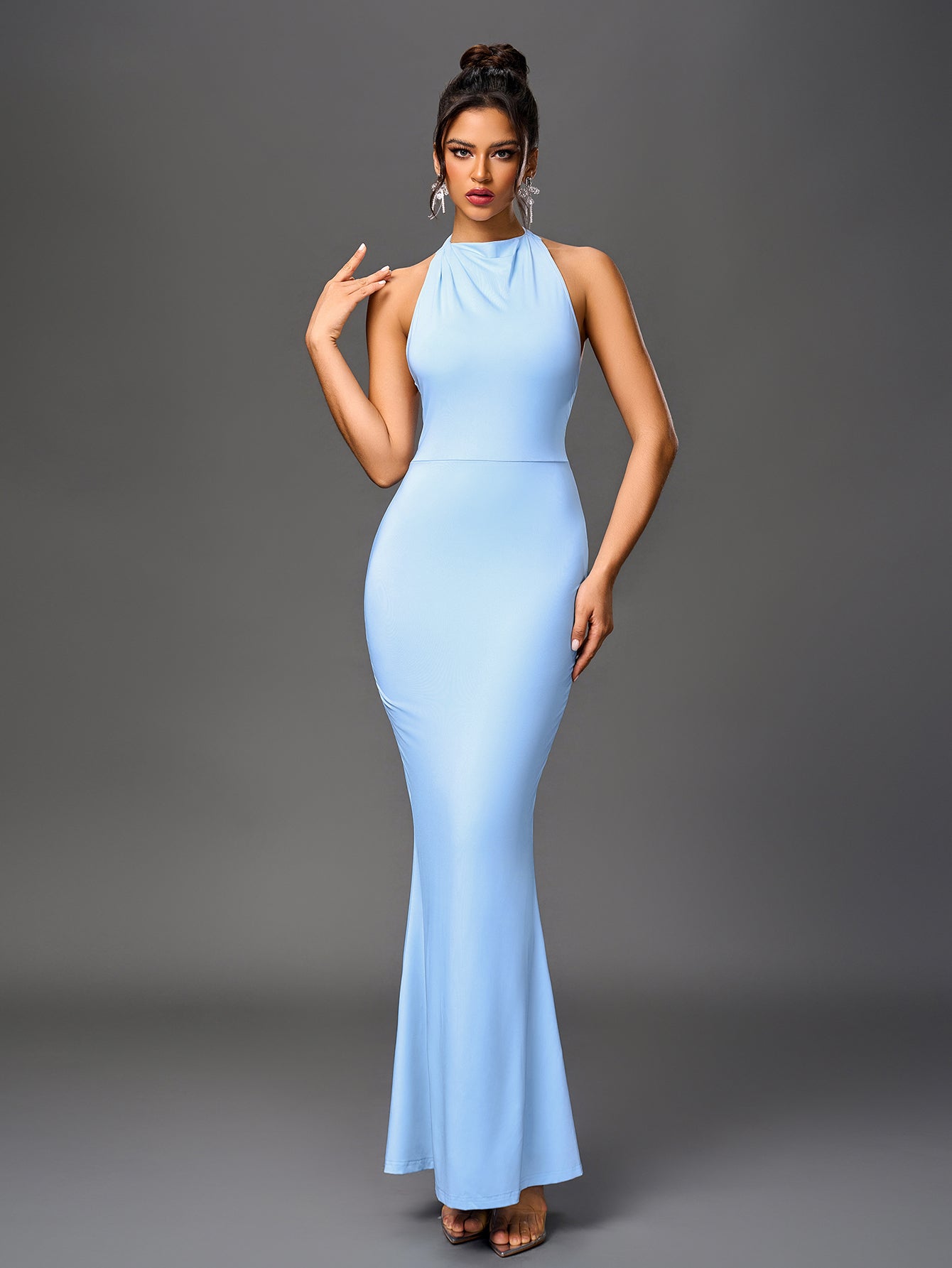 Front view of a woman in an elegant light blue mermaid gown.