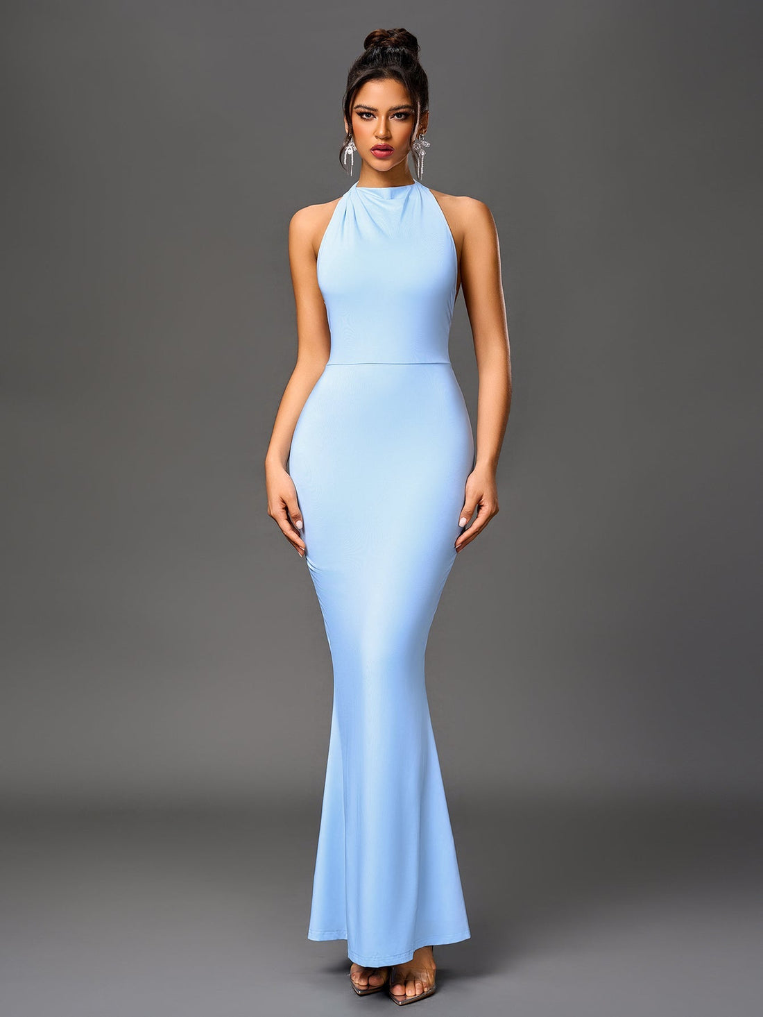 Woman wearing a light blue floor-length mermaid gown with a halter neckline.