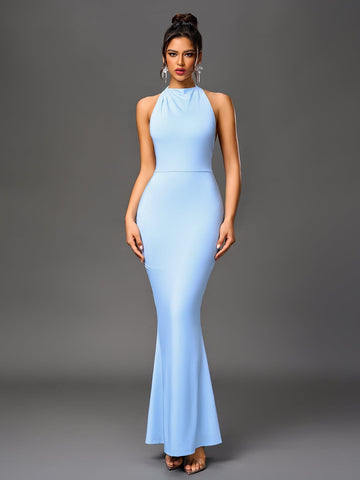 Woman wearing a light blue floor-length mermaid gown with a halter neckline.
