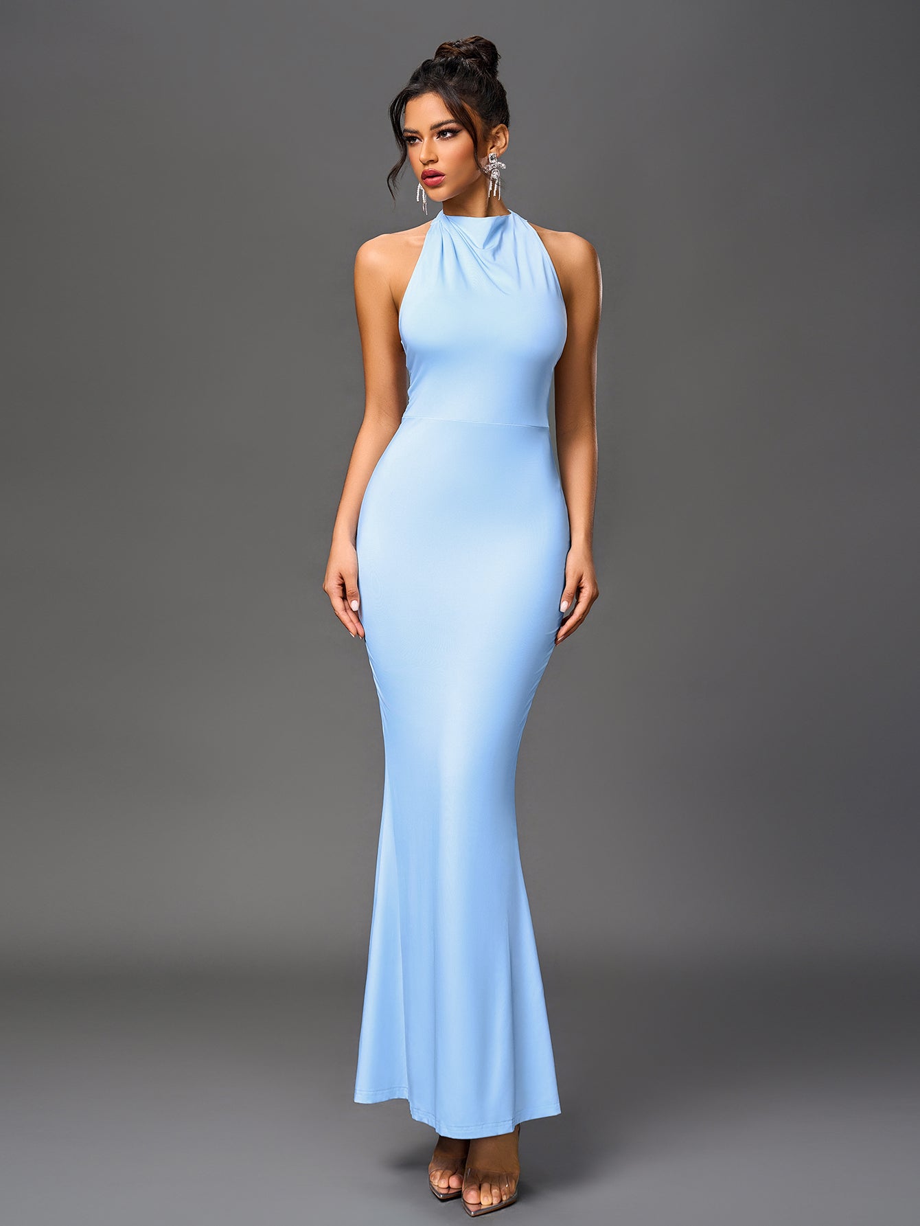 Full-body shot of a woman in a light blue halter neck mermaid dress.