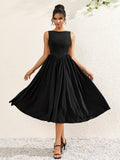 woman wearing a sleeveless black crepe midi dress with a boat neckline and flared skirt