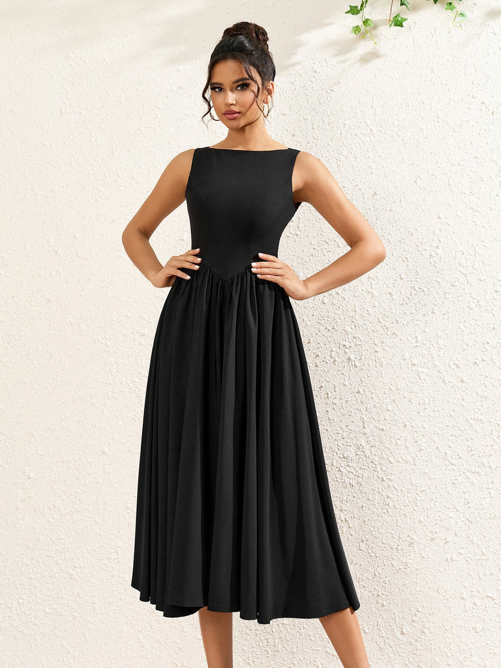 woman posing in a sleeveless black crepe midi dress with a boat neckline and flared hem