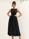 woman posing in a sleeveless black crepe midi dress with a boat neckline and flared hem