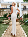 Rear view of a woman in a white sleeveless ribbed knit mermaid gown.