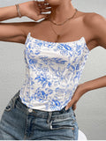 Close-up of a woman in a white and blue floral print corset top, highlighting the fabric texture and print.
