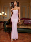Woman wearing a floor-length pink sequined mermaid dress with a square neckline and spaghetti straps.