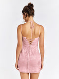 Back view of a pink floral jacquard sheath dress with a lace-up back detail and spaghetti straps.