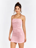 Front view of a woman wearing a pink floral jacquard sheath dress with spaghetti straps.