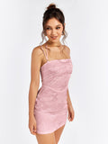 Woman posing in a pink floral jacquard sheath dress with a square neckline and spaghetti straps.