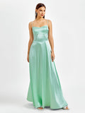 Woman posing in a mint green satin maxi dress with a sweetheart neckline.