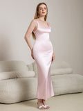 Full-length view of a woman in a pink satin column dress with a square neckline.