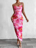 Woman wearing a pink floral print ruched bodycon midi dress with spaghetti straps and a side slit, viewed from the back.