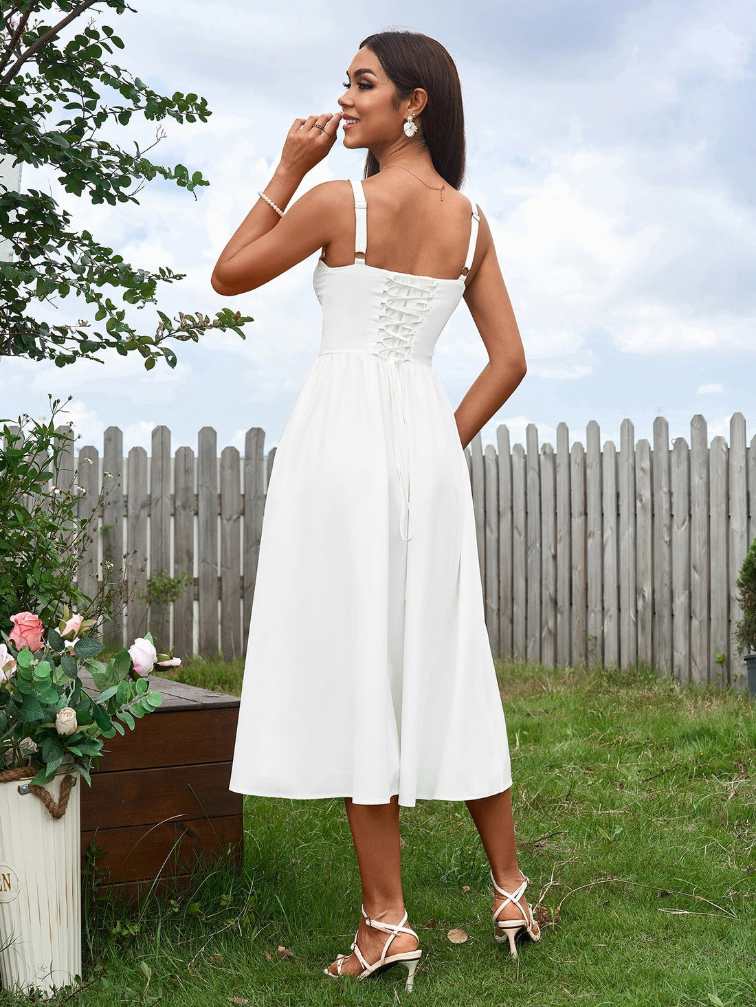 woman in white linen blend dress with corset bodice and high slit