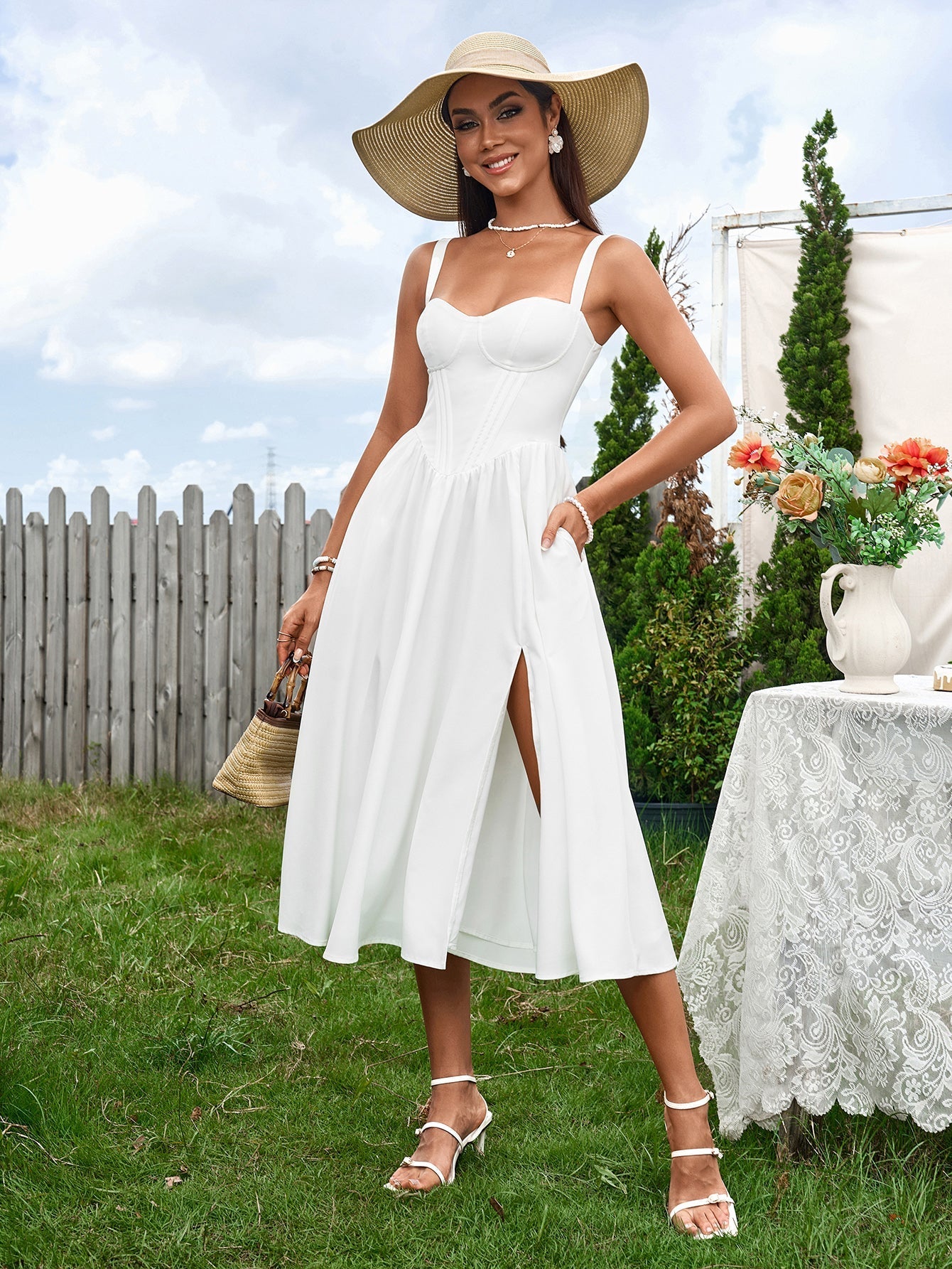 woman in white linen blend dress with corset bodice and high slit