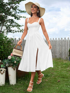 woman wearing a white linen blend dress and wide-brimmed hat