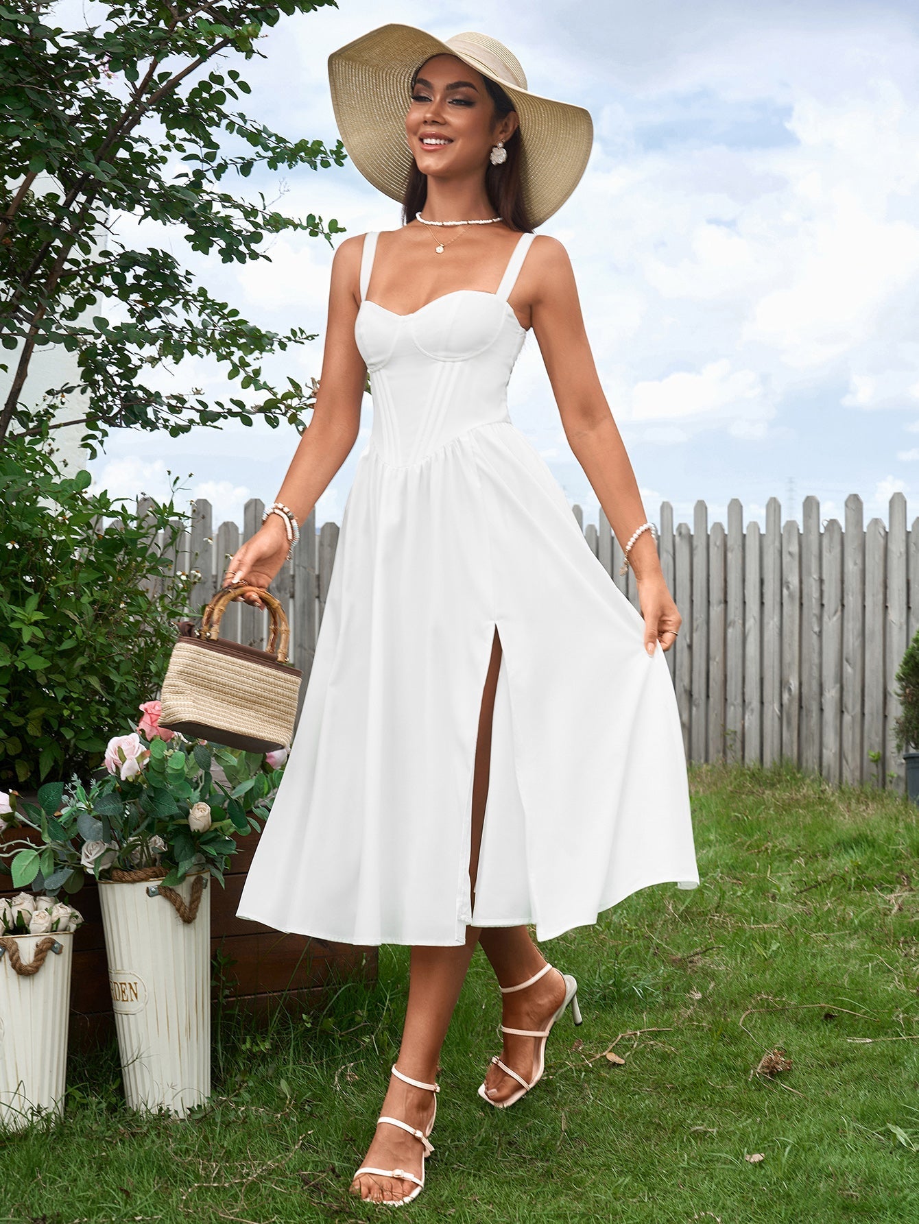 woman wearing a white linen blend dress and wide-brimmed hat