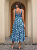 Back view of a woman in a blue floral print midi dress with a square neckline and wide straps.