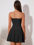 Back view of a woman in a black strapless corset dress