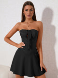 Woman in a black strapless corset dress with lace-up front detail