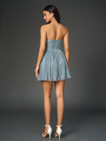 back view of a woman in a blue strapless party dress