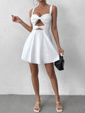 woman wearing white bow detail mini dress and holding black handbag