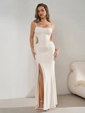 Full length view of a woman in an elegant white evening dress.