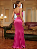 Back view of a fuchsia satin mermaid gown with a high slit and back cutout.