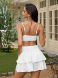 Back view of woman in white cut-out tiered dress
