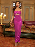 Woman standing in a magenta strapless column gown with a cutout bust and high slit