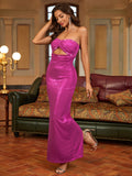 Woman posing in a magenta strapless column gown with a cutout bust and high slit