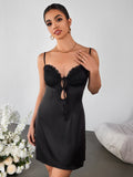 Close-up of the lace bust on a black cami dress